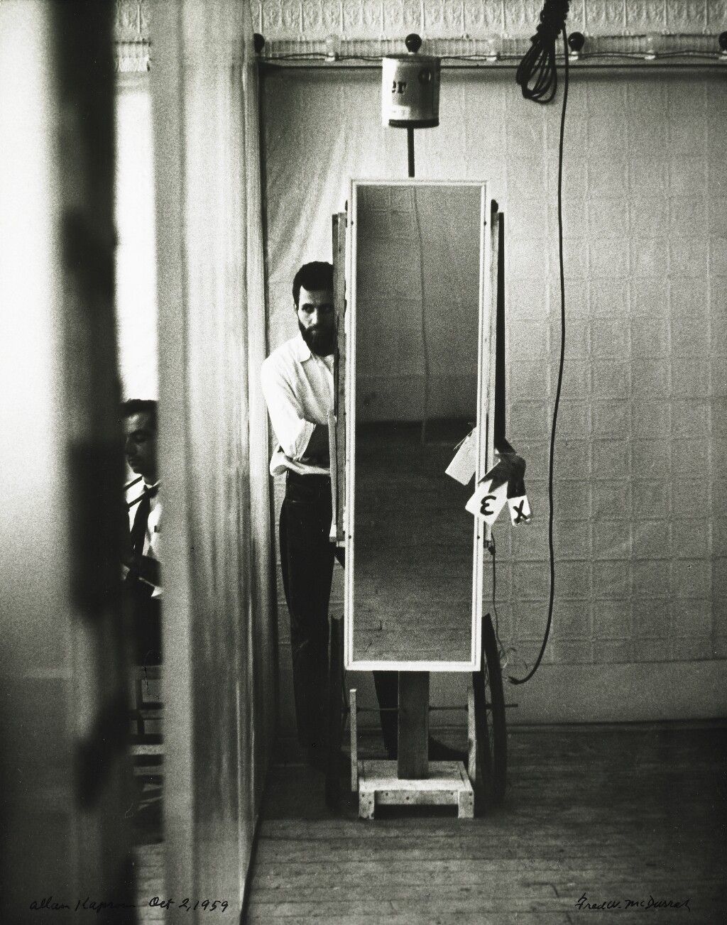 Allan Kaprow with the “Sandwich Man” during 18 Happenings in 6 Parts at the Reuben Gallery, New York, photographed by Fred W. McDarrah on 2 October 1959.