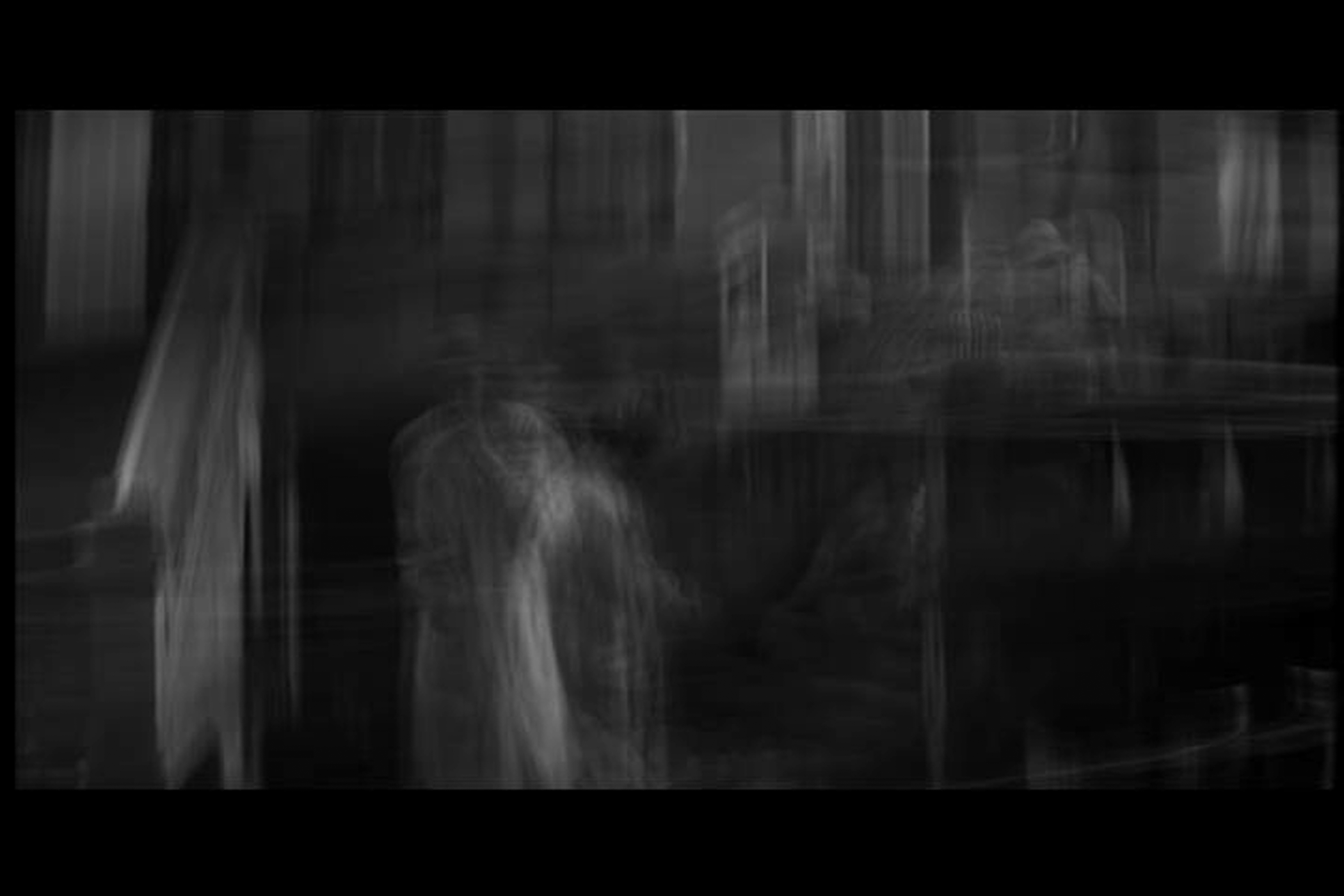 A black-and-white Academy video still merges film imagery into translucent vertical traces inside a black border.