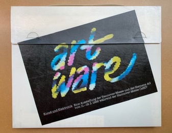 The 1986 art ware: Kunst und Elektronik catalogue photographed in its original plastic carrying case, printed with the exhibition's dates during the Hannover CeBIT fair.