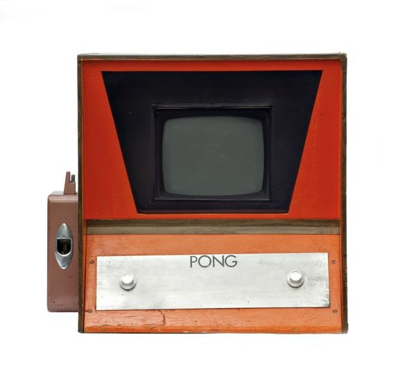Orange-and-brown wooden Pong prototype cabinet, with a small television and two rotary controls.