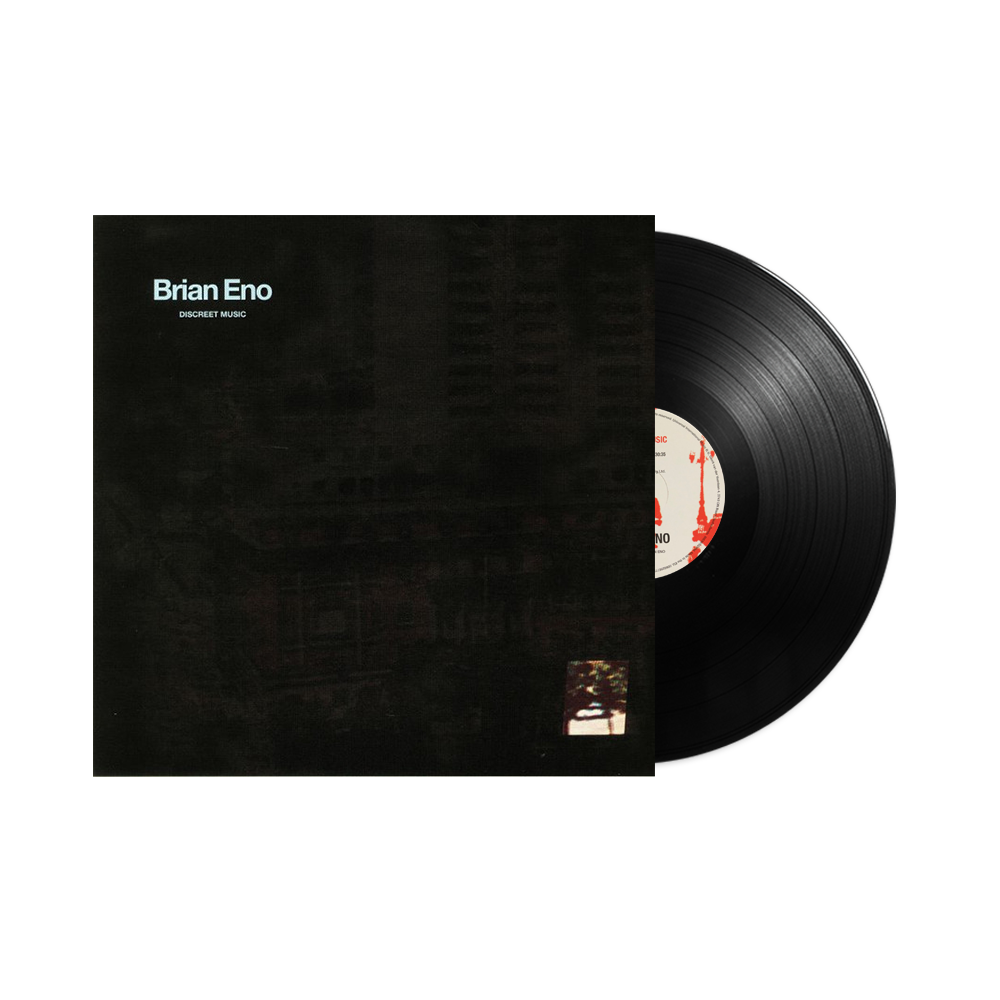Discreet Music sleeve with Brian Eno's name at the upper left on a dark image, beside a partially visible black vinyl record, on the label's white product background.