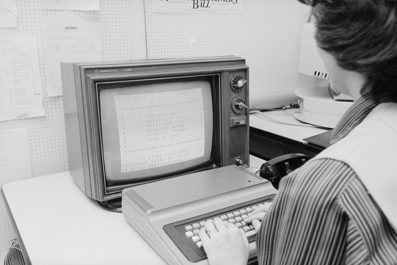 A woman at the Washington Post using CompuServe on a TRS-80 Color Computer in April 1981; a documentary photograph of the service that introduced the GIF in 1987, not of the format itself.