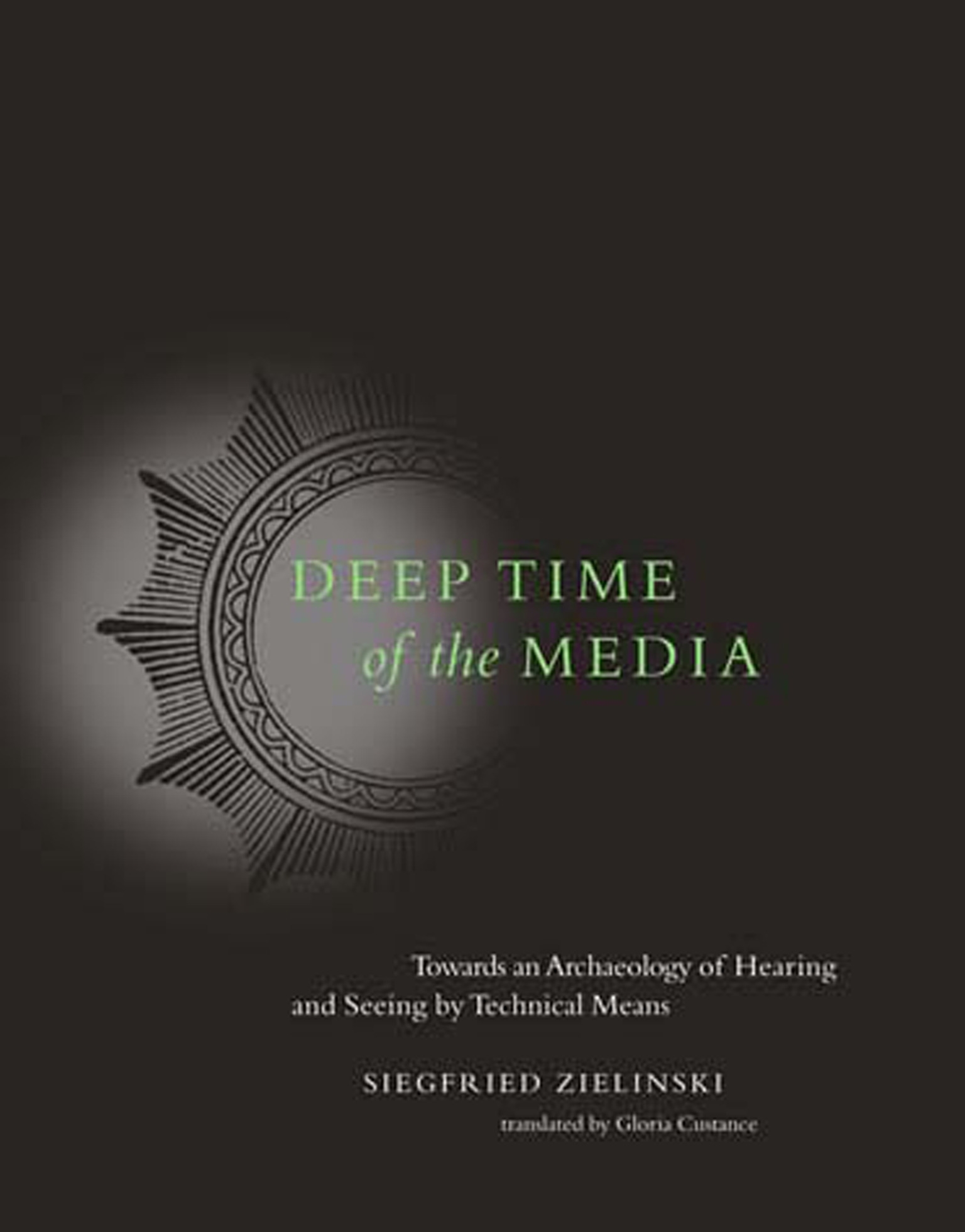 Dark brown Deep Time of the Media cover with a circular instrument motif, green title lettering and the author and translator names below.