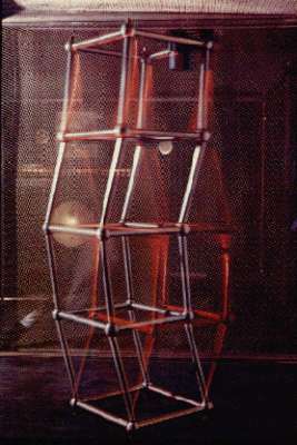 An exhibition photograph filed with Compart's record of Electromagica '69, showing a tall open lattice sculpture of rods and joints under red illumination.