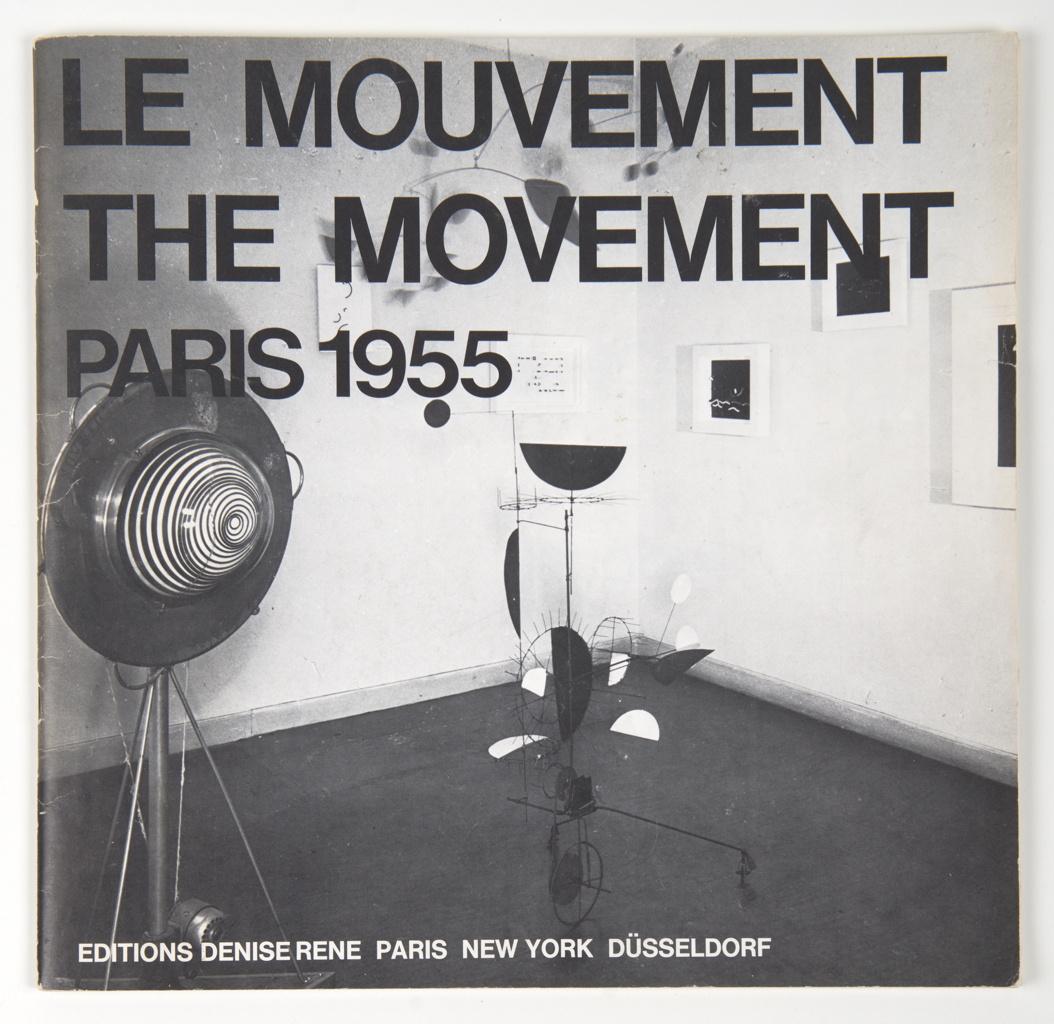 Le Mouvement catalogue cover showing a black-and-white gallery installation with a spiral disc and hanging abstract sculpture.