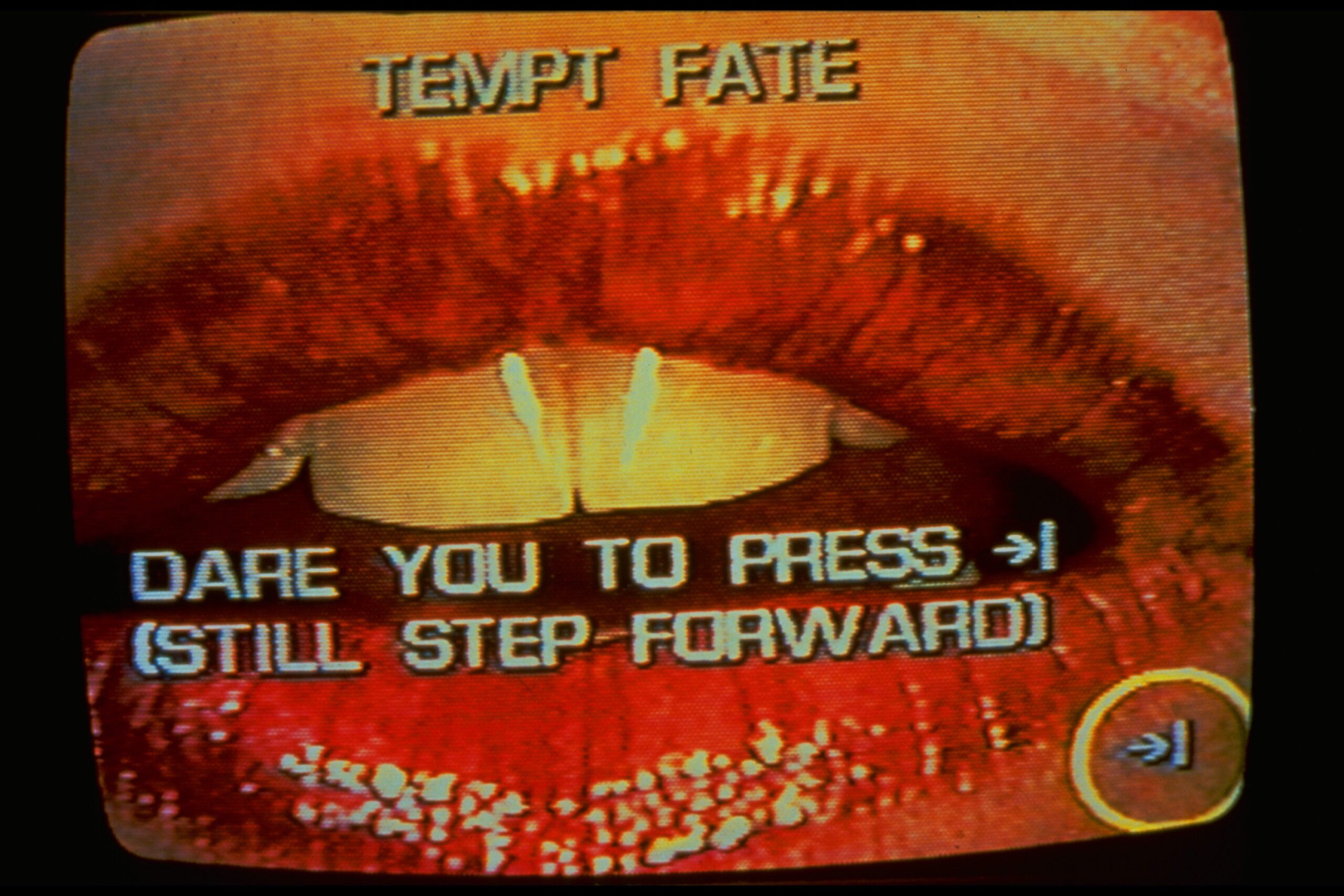 Lorna's video interface shows a close-up of red lips on a curved television screen, with the prompts ‘Tempt Fate’ and ‘Dare you to press’ above a still-step-forward control.
