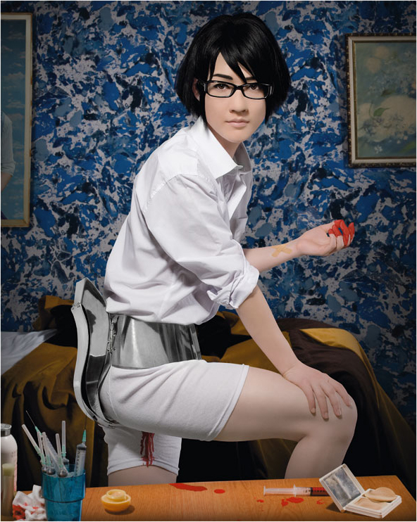 Takashi, the protagonist of Sputniko!'s Menstruation Machine, wearing the metal belt-like device -- electrodes and blood-dispensing mechanism visible -- against the film's patterned blue interior.