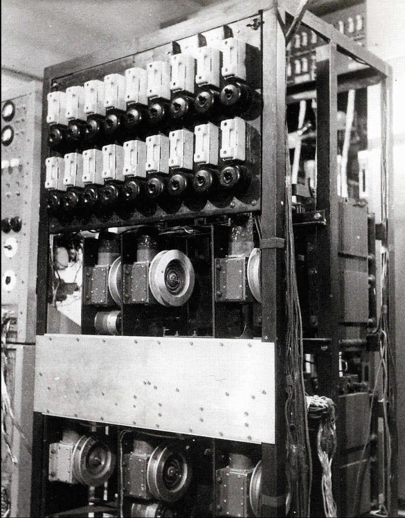 Black-and-white archival photograph of the Musicolour apparatus, showing rows of dials, electrical components and large circular mechanisms in an open cabinet.