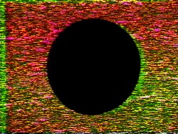 A black circle is surrounded by dense red, yellow and green electronic video noise.