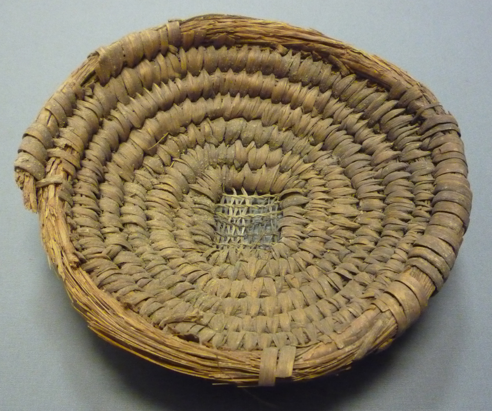 A coiled reed basket from New Kingdom Egypt — a contextual image of the coiling technique, not the Upper Palaeolithic evidence itself.