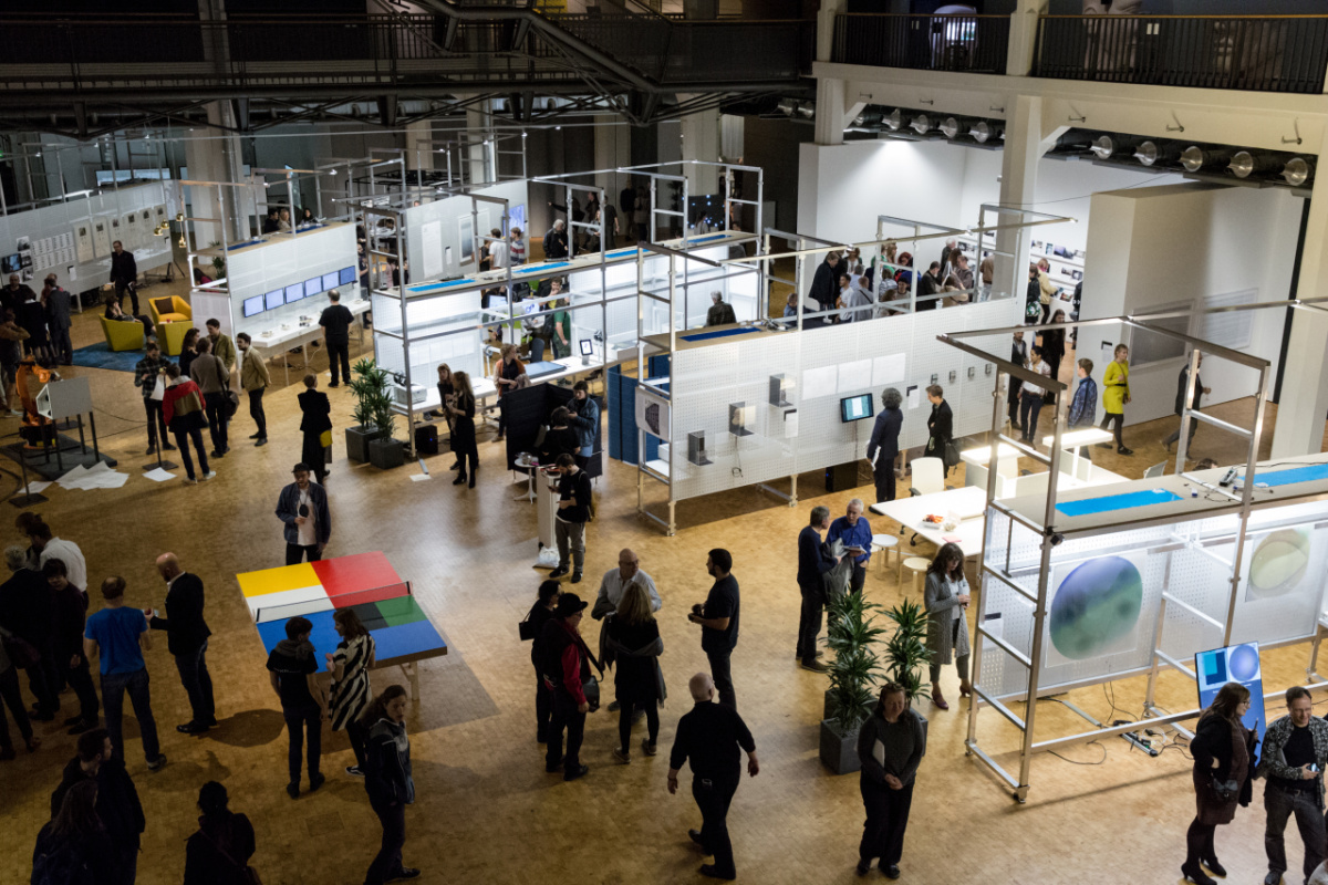 Visitors explore screens and installations in the open exhibition hall of Open Codes.