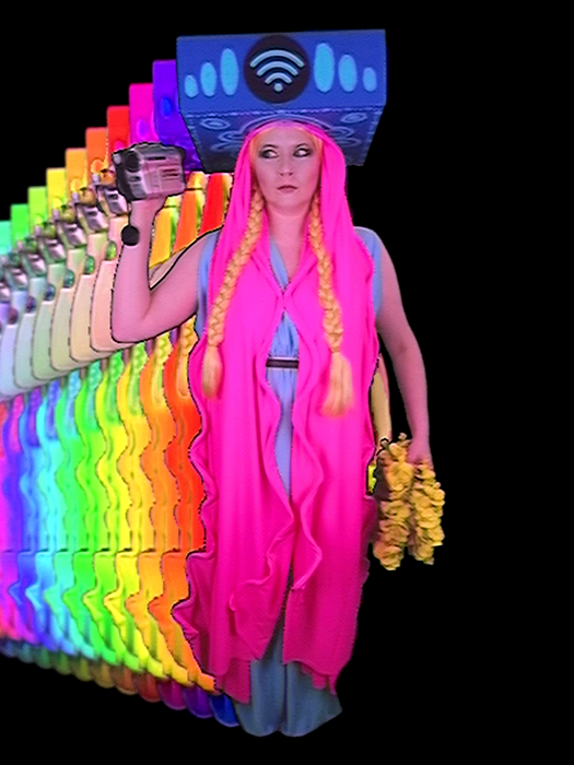 A pink-clad figure holding a camcorder repeats in a trail of rainbow-colored analog video echoes.