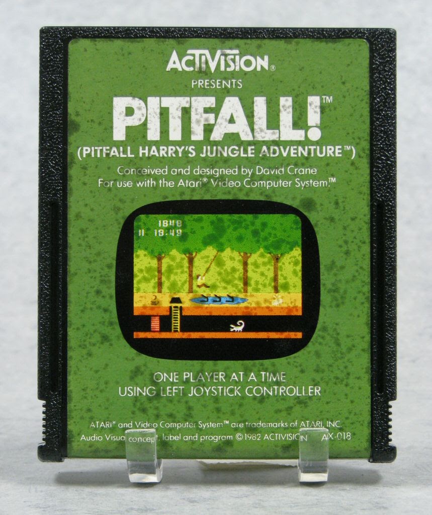 A black Atari cartridge with the green Pitfall! label and an image of the jungle platform game.