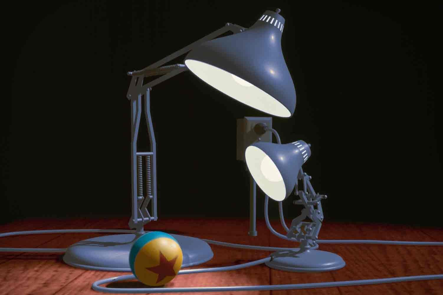 Two articulated desk lamps face a small ball decorated with a red star against a dark background in Luxo Jr.