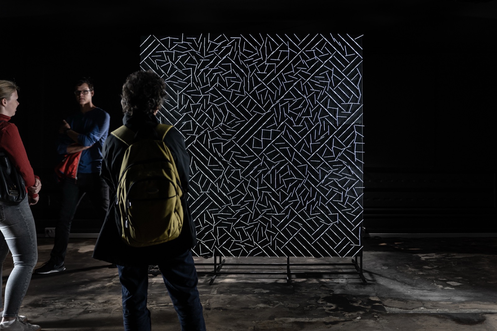 Installation view of the two-by-two-metre grid of 1,250 stepper motors, each carrying a white acrylic pointer.