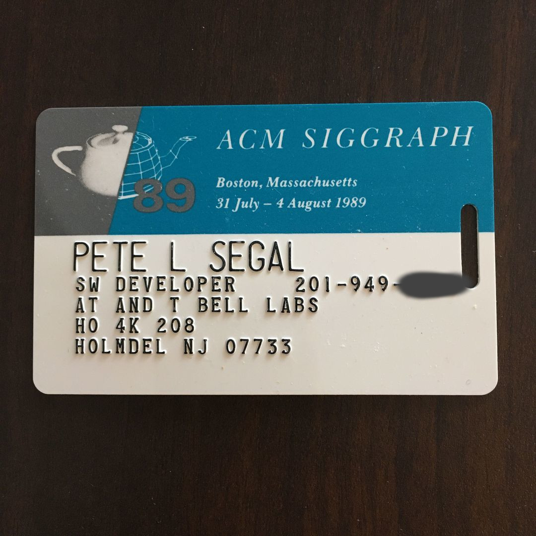 A photograph of an embossed attendee badge from ACM SIGGRAPH '89, printed with the conference's Utah teapot mark and the dates 'Boston, Massachusetts, 31 July - 4 August 1989'.