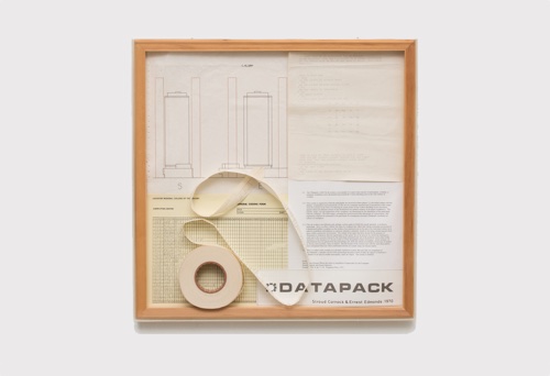 Framed documentation of Datapack with a magnetic-tape reel and diagrammed instructions.