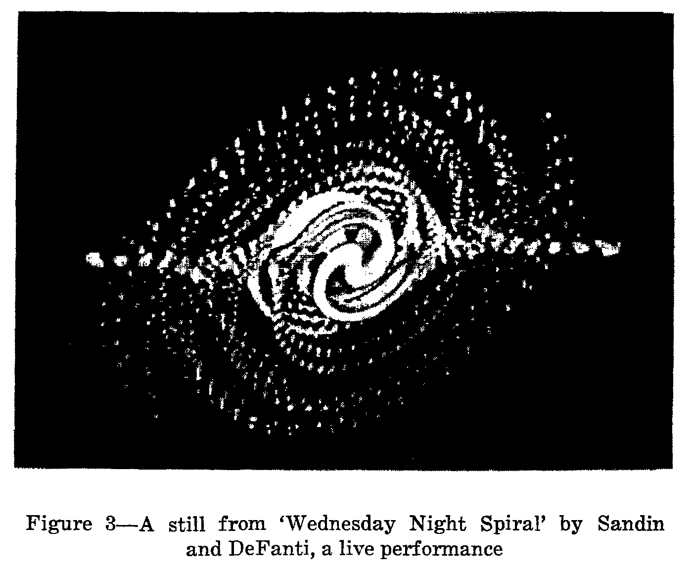 A spiral of bright calligraphic forms on black, with the original printed caption identifying Wednesday Night Spiral by Sandin and DeFanti.